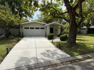 View of front of home featuring an attached garage and concrete driveway