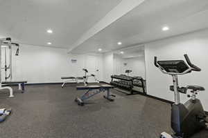Workout room featuring a textured ceiling and recessed lighting