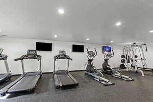 Workout area with a textured ceiling and recessed lighting