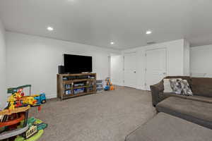 Living area featuring recessed lighting and carpet flooring