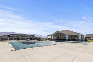 Community pool with a patio, a mountain view, and a residential view