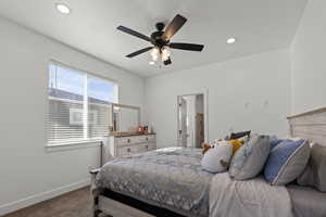 Carpeted bedroom with recessed lighting, ceiling fan, and ensuite bathroom