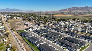 Aerial overview of property's location with mountains and nearby suburban area
