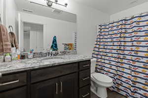 Bathroom with vanity, wood finished floors, and curtained shower