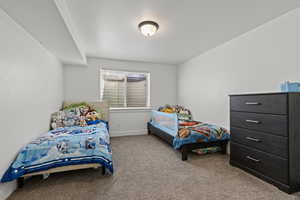 Bedroom with light carpet and baseboards