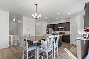 Dining room featuring light wood-style flooring, recessed lighting, and a chandelier