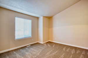 Carpeted front entry room. Could be office, den, music room, or formal living room.