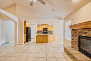 Living room with lofted ceiling, arched walkways, and a fireplace