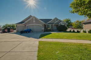 Craftsman inspired home featuring concrete driveway, a garage, stucco siding, and stone siding