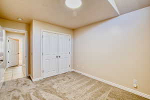 Unfurnished bedroom with carpet floors and a closet