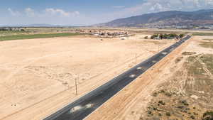 Aerial view of sparsely populated area with a mountain backdrop and a desert landscape