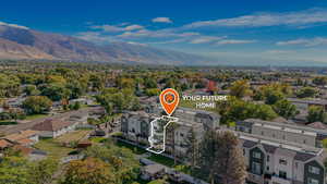Aerial perspective of suburban area featuring a mountain backdrop