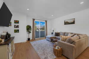 Living room featuring light wood finished floors and recessed lighting