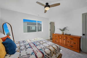 Bedroom featuring light colored carpet and ceiling fan