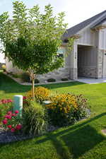 View of grassy yard with an attached garage