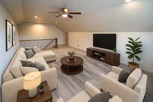 Carpeted living room with lofted ceiling, recessed lighting, and a ceiling fan