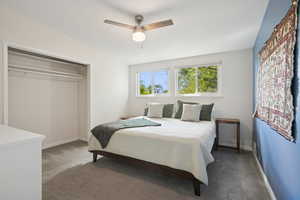 Bedroom with carpet floors, a ceiling fan, and a closet