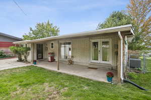 Rear view of house with brick siding, french doors, and entry steps