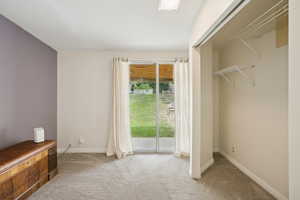 Unfurnished bedroom featuring light colored carpet and access to outside