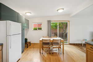 Dining area featuring light wood-style flooring and baseboards