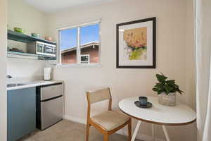 Dining room featuring baseboards and light carpet