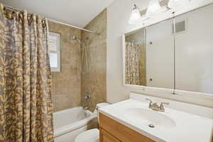Bathroom featuring shower / tub combo and vanity