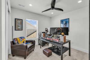 Office area with light colored carpet, recessed lighting, and a ceiling fan