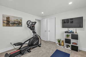 Exercise room with carpet flooring and recessed lighting