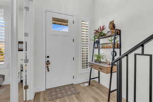 Entryway featuring light wood finished floors and stairway