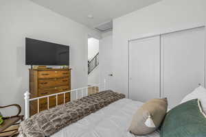 Bedroom featuring a closet and attic access