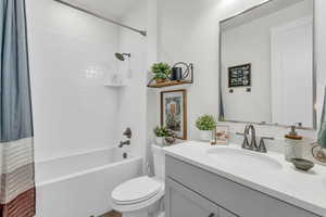 Bathroom with shower / bath combo and vanity