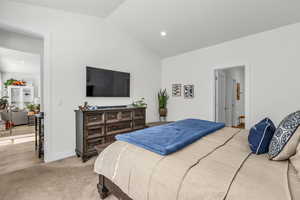 Bedroom with vaulted ceiling, recessed lighting, and light colored carpet