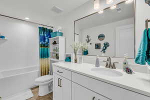 Full bath featuring vanity, shower / bath combo, light tile patterned flooring, and recessed lighting
