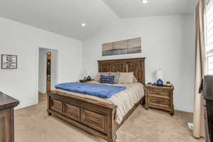 Bedroom with lofted ceiling, light colored carpet, and recessed lighting
