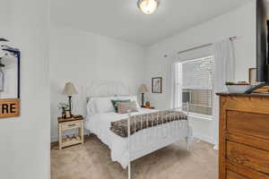 Bedroom with light carpet