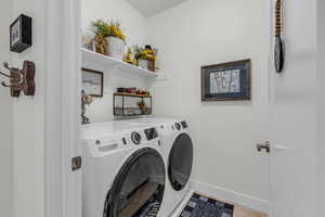 Laundry area with baseboards and separate washer and dryer