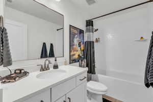 Bathroom with shower / bath combo with shower curtain and vanity