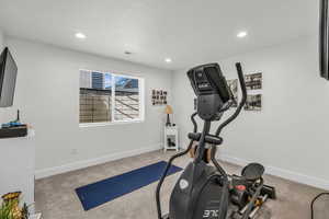 Exercise area featuring recessed lighting and light colored carpet