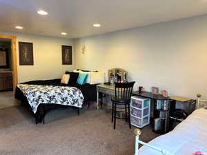 Bedroom with recessed lighting, carpet floors, and connected bathroom