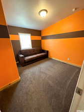 Sitting room with dark carpet and a textured ceiling