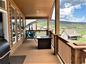 Wooden terrace featuring area for grilling