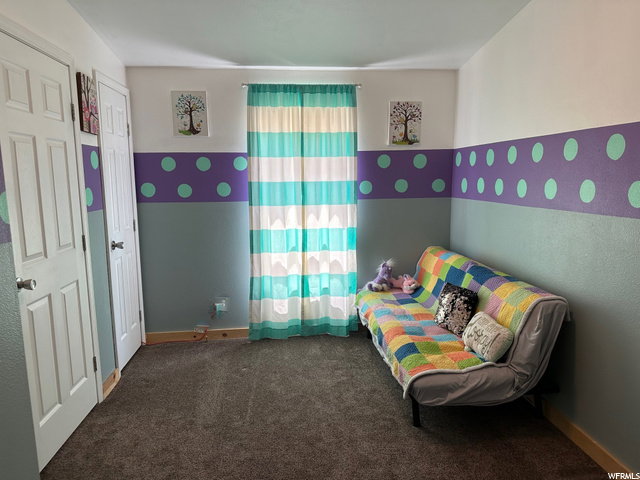 Bedroom with carpet floors and baseboards