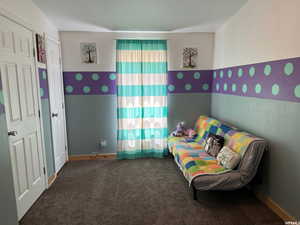 Bedroom with carpet floors and baseboards