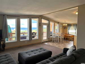 Carpeted living area with a chandelier and a mountain view
