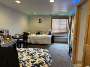 Bedroom featuring light carpet, recessed lighting, and baseboard heating