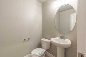 Bathroom featuring toilet and baseboards