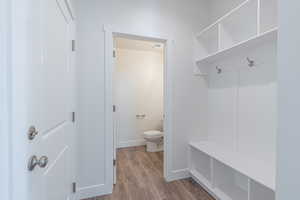 Mudroom with dark wood-style floors and baseboards
