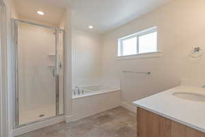 Full bathroom with a bath, a shower stall, vanity, and recessed lighting