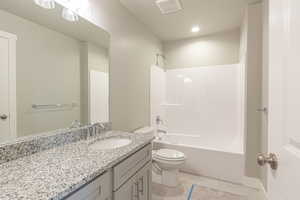 Full bath featuring shower / washtub combination, vanity, light tile patterned floors, and recessed lighting