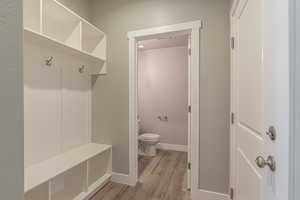 Mudroom featuring wood finished floors and baseboards